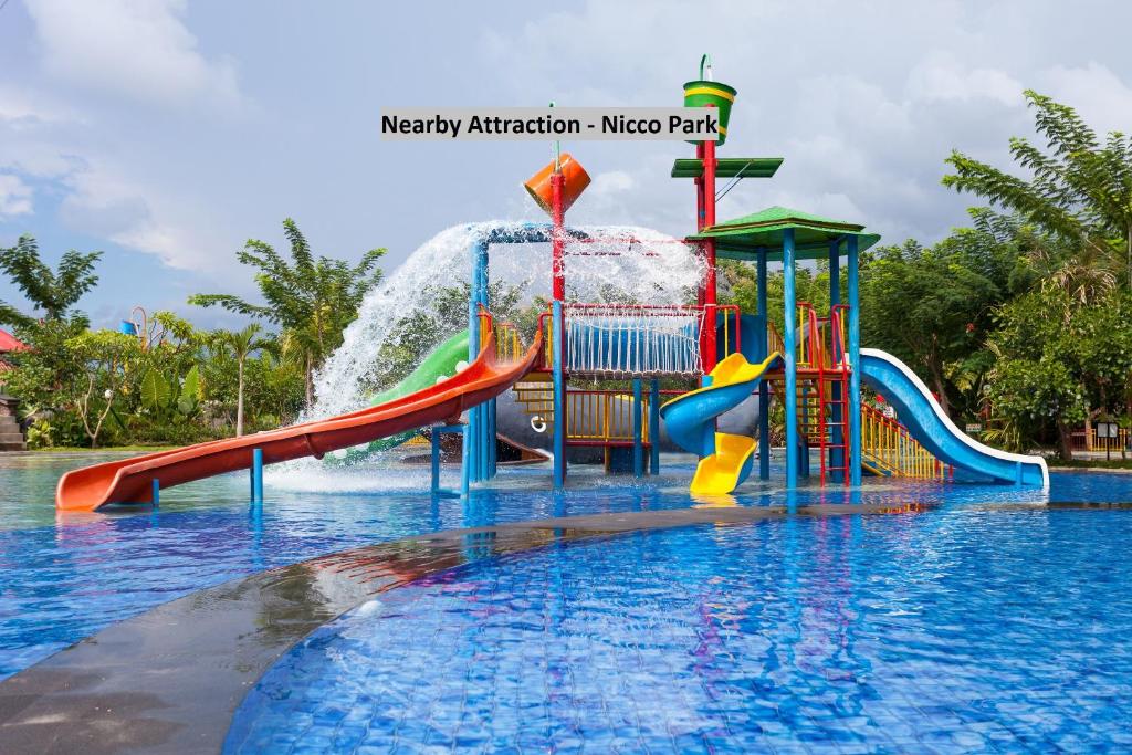 a water park with a water slide in the water at OYO Flagship Maple The Residence Near RDB Cinemas in Thākurdwari