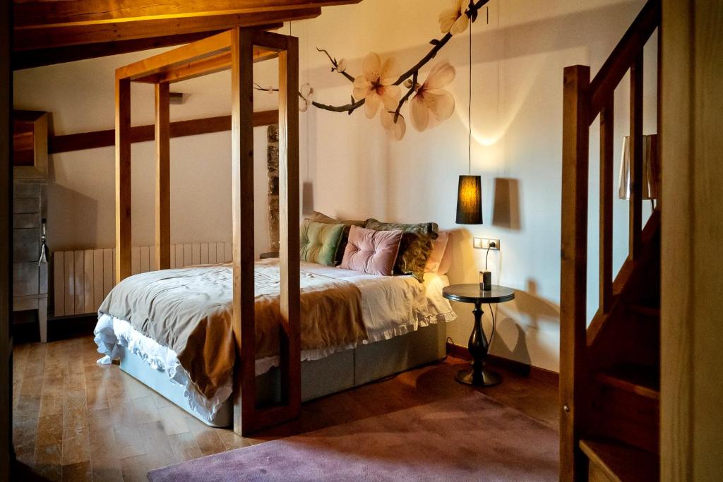 a bedroom with a canopy bed in a room at Hotel Rural Flor de Almendro in Loarre