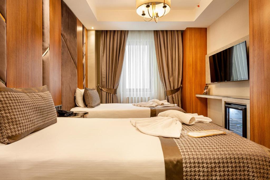 Postel nebo postele na pokoji v ubytování Santra Hotel