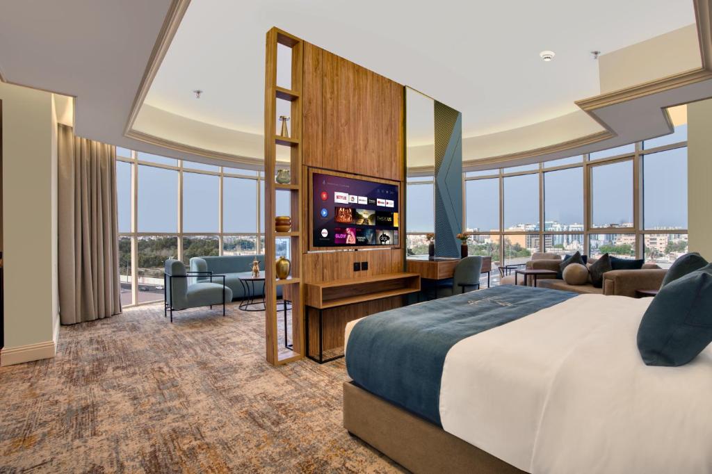 a hotel room with a bed and a flat screen tv at ِAluya Hotel in Jeddah