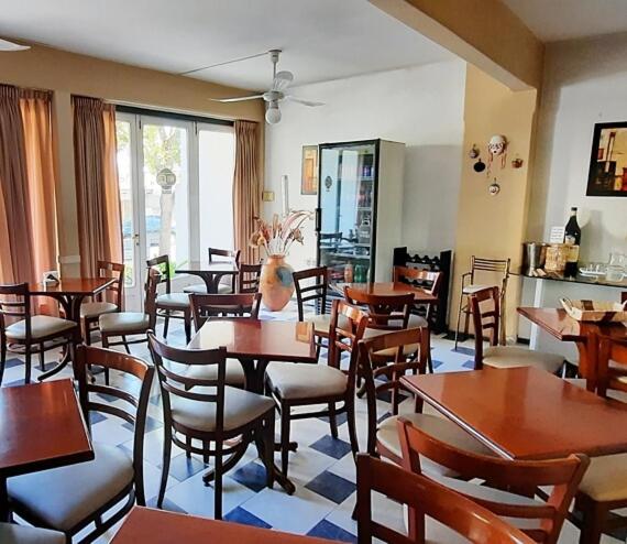a restaurant filled with wooden tables and chairs at Hotel San José in Villa Carlos Paz