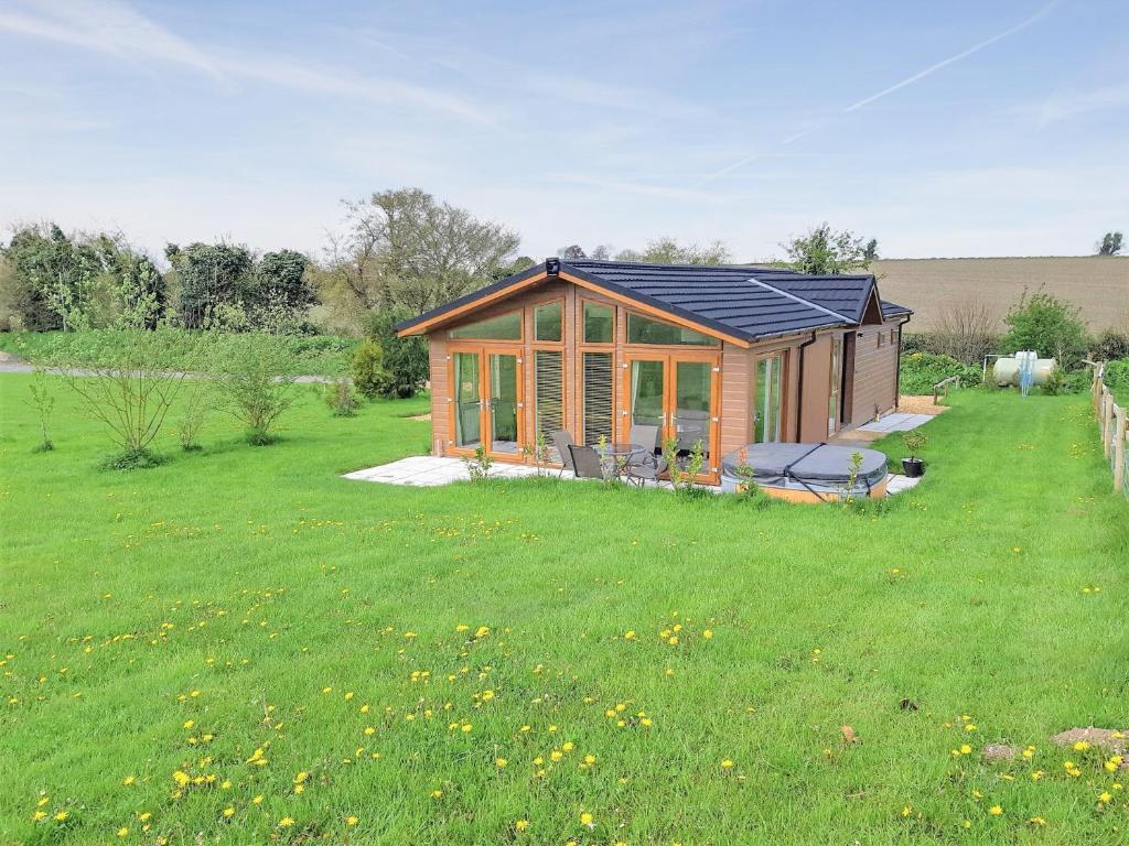 a house with a solar roof on a grass field at Whitey Top Country Lodge in Pentridge