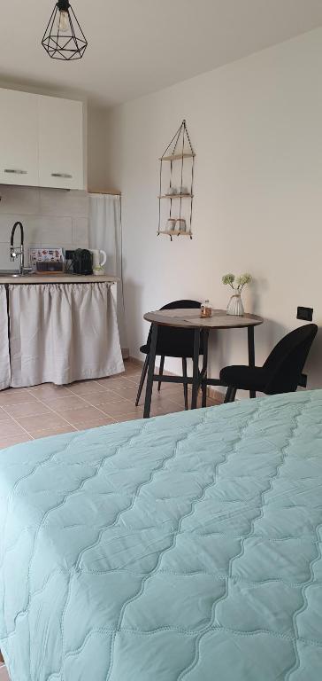 a kitchen with a table and a blue blanket at Eleonora's apartment in Olbia