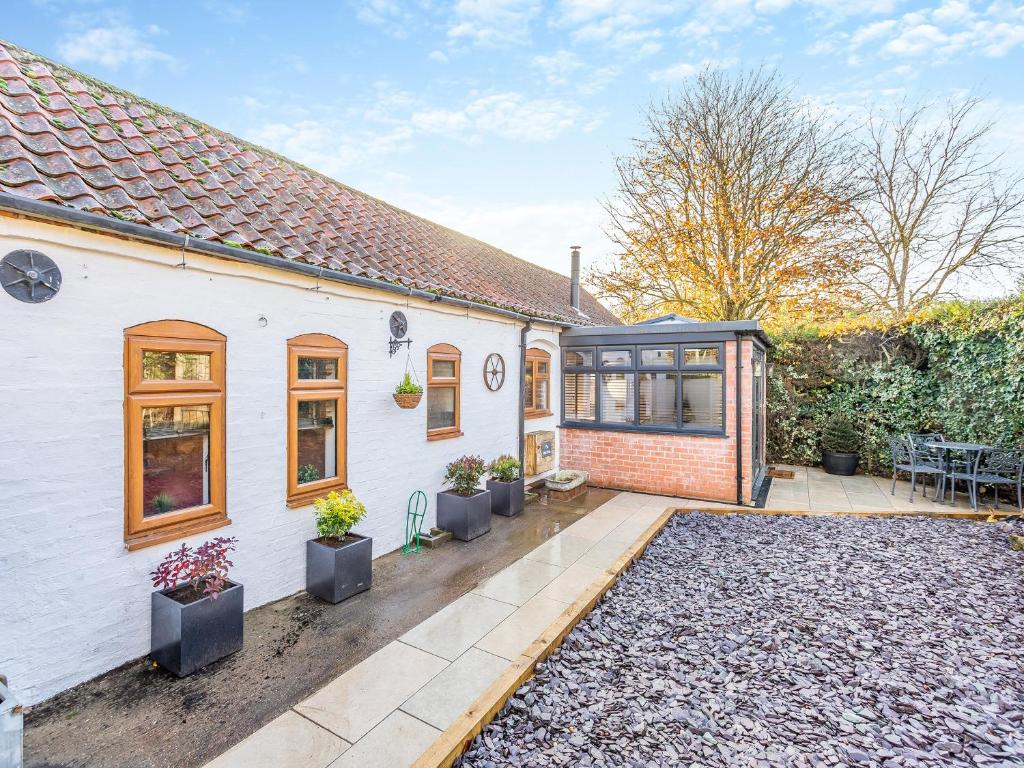 an exterior view of a house with a patio at The Stables in Sproxton