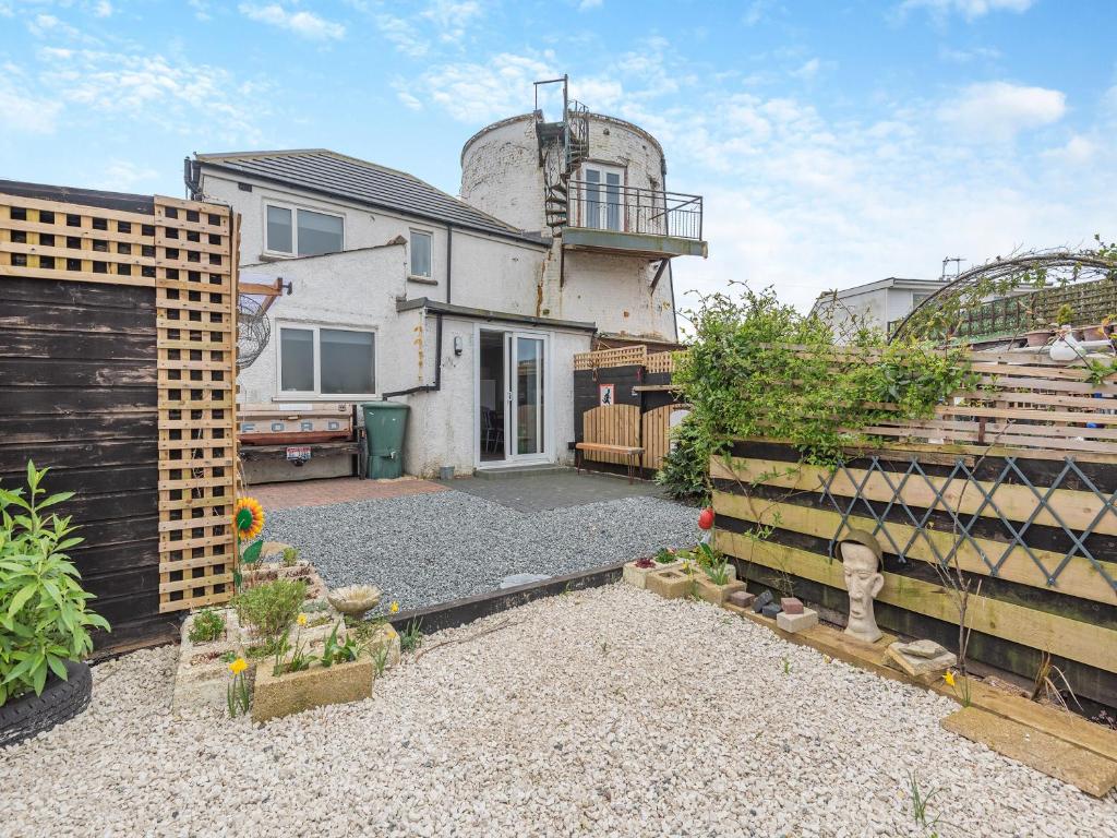 a backyard of a house with a silo at Mill House in Trusthorpe