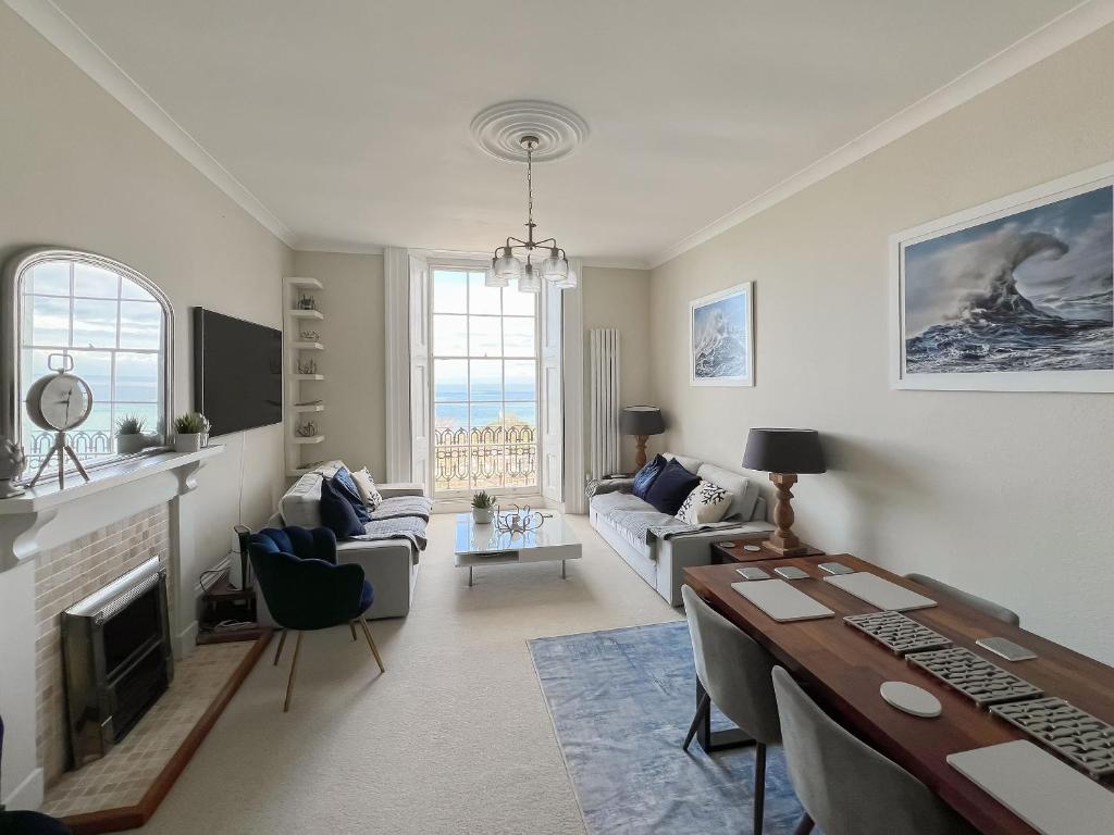 a living room with a couch and a table at Admirals Lookout in Ilfracombe