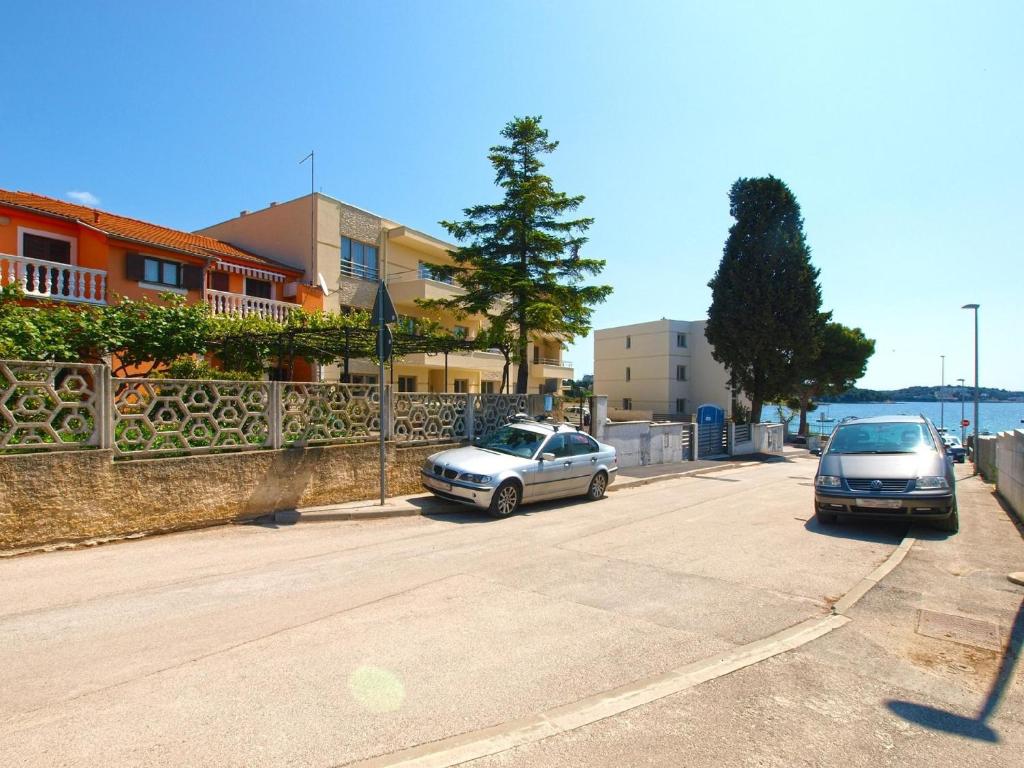 two cars parked in a parking lot next to a building at Ferienwohnung für 4 Personen ca 55 qm in Pula, Istrien Istrische Riviera - b62498 in Pula