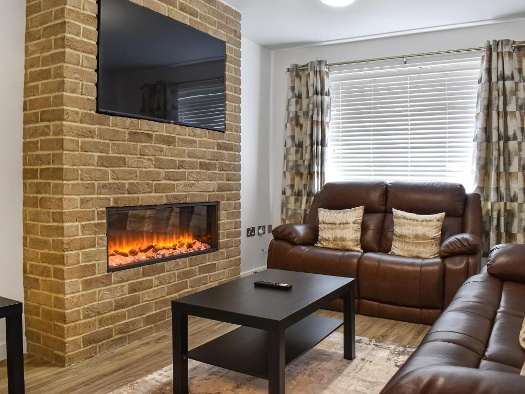 a living room with a couch and a fireplace at Gadebridge in Thornaby on Tees