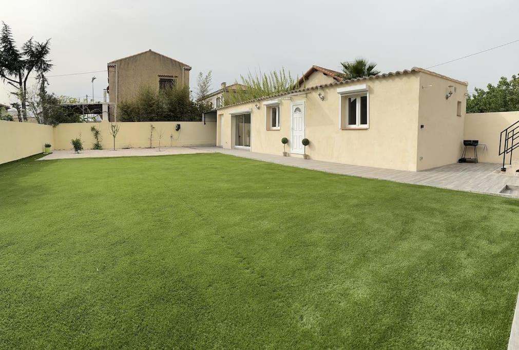 a large lawn in front of a house at Maison entièrement Neuve in Marseille