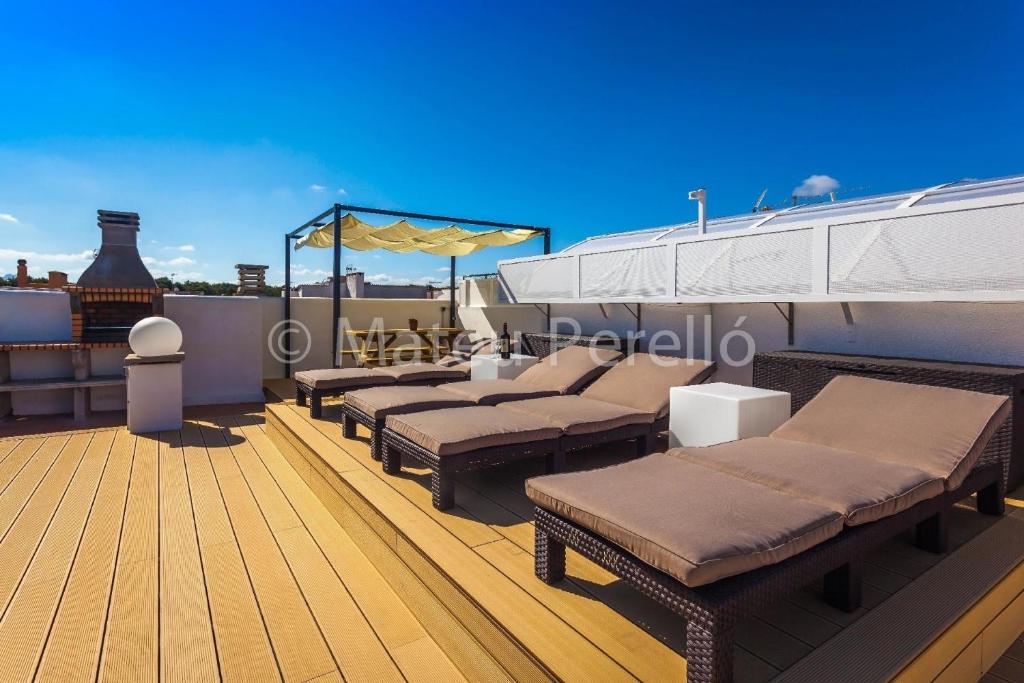a deck of a boat with chaise lounges on it at Appartement in Son Baulo mit Grill in Can Picafort