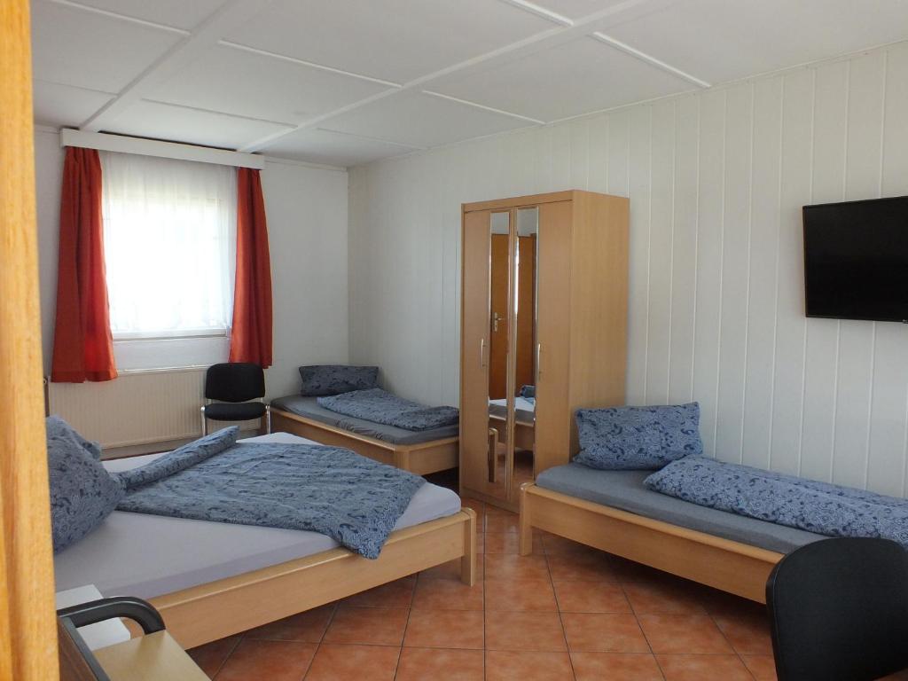 a room with two beds and a tv at Bungalow 1 in Pruchten