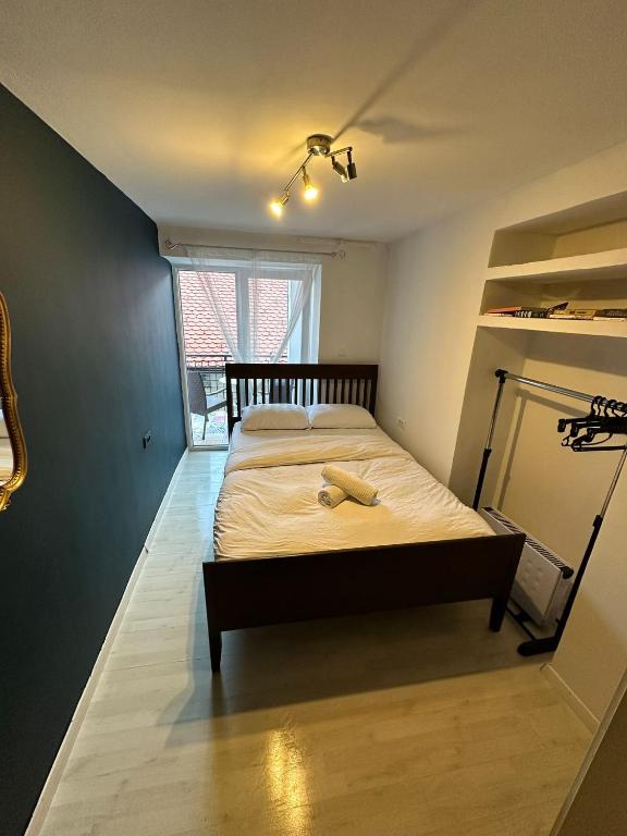 a bedroom with a bed with a wooden head board at Hostel Sleeping Beauty in Ljubljana