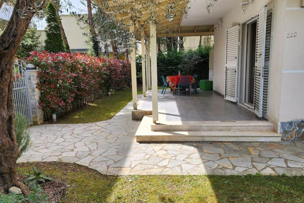 a porch of a house with a table and chairs at Alba's House Lura1 Residence in Draç