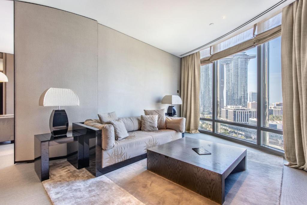 a living room with a couch and a table at Burj Khalifa, Armani hotel 1 bedroom apartment in Dubai