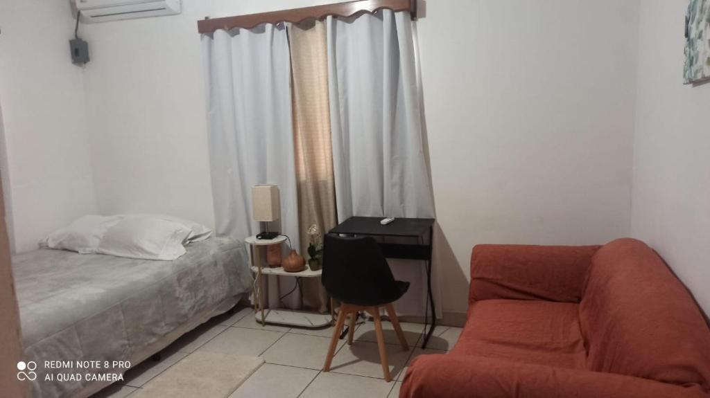 a bedroom with a bed and a chair and a desk at LA CASA DE DON MATILDE in San Pedro Sula