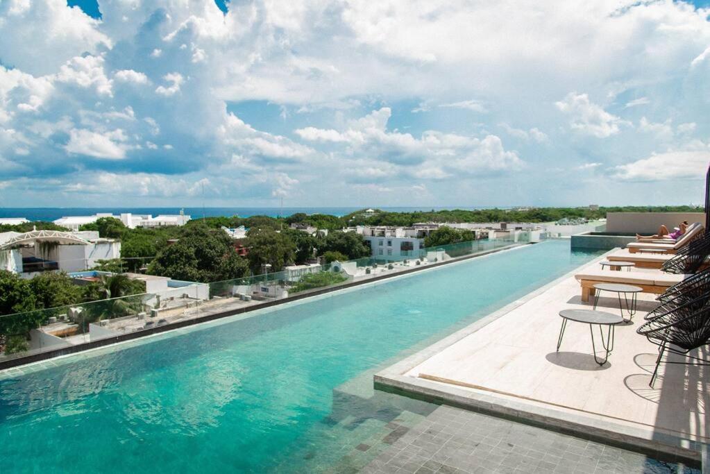 a swimming pool with a view of the ocean at 2BED 3BATH 2 blks 5th beach shop in Playa del Carmen