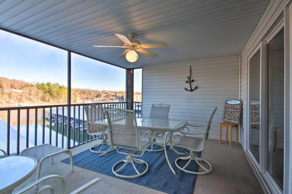 a patio with a table and chairs on a balcony at Waterfront Condo with Boat Slip! in Lake Ozark