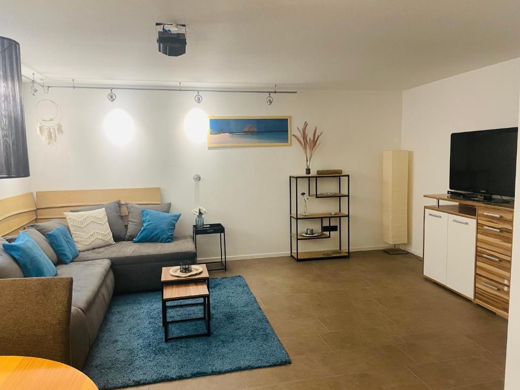 a living room with a couch and a flat screen tv at Ferienwohnung in Diemelsee Adorf in Diemelsee