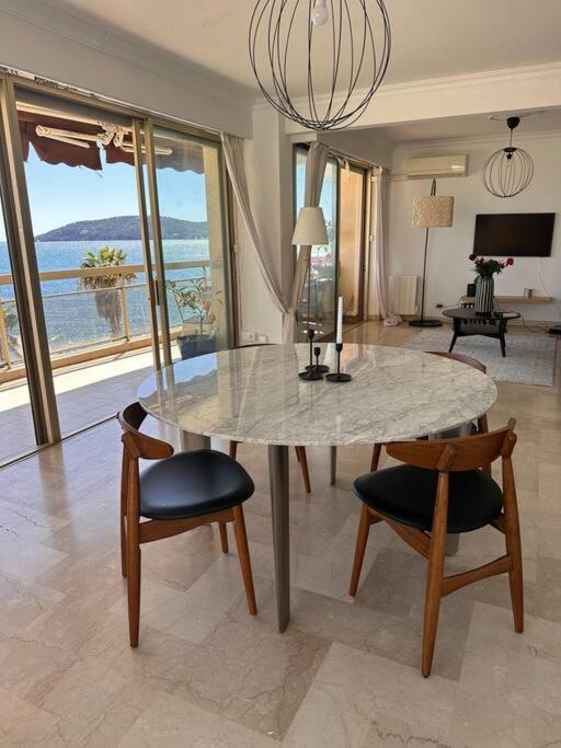a dining room with a table and chairs with a view at Appartement panoramique sur mer in Toulon