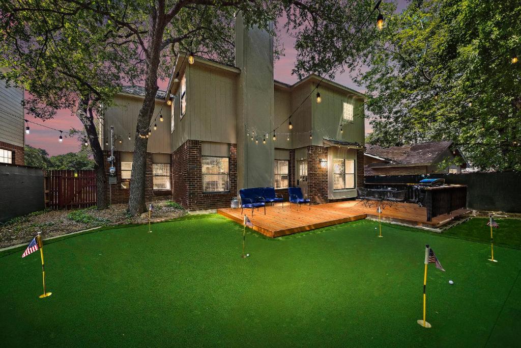 a house with a putting green with golf balls on it at Sa Golf Home Nr Six Flags Wi-fi Bbq Games in San Antonio