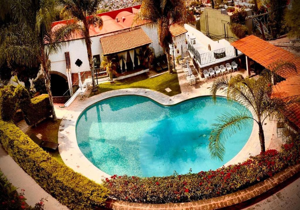 an overhead view of a large swimming pool in front of a house at Hotel Posada la Ermita in San Miguel de Allende