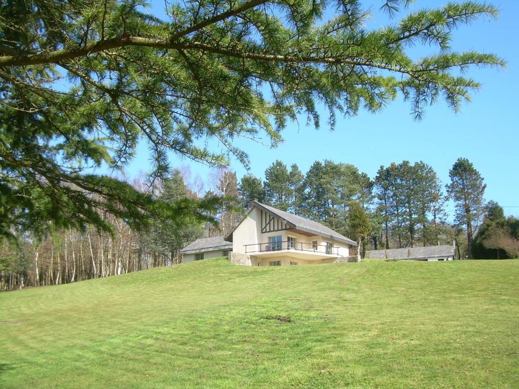 a house on top of a grassy hill at Gadeyne Nathalie Le chalet de Malvoue in Vimoutiers