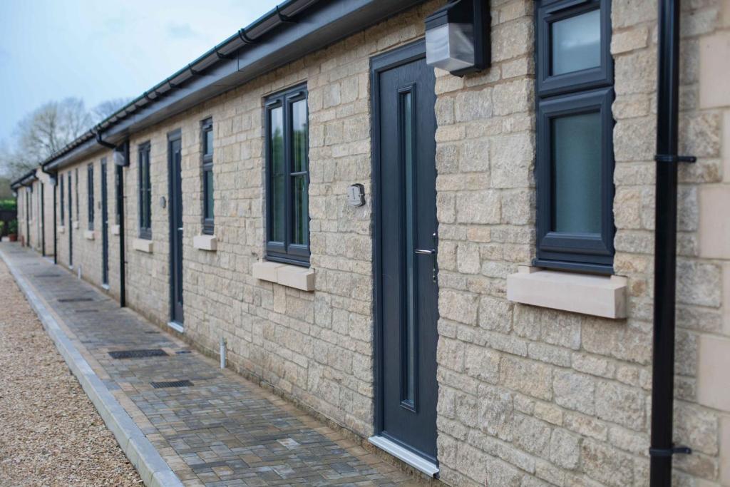 a row of windows on a brick building at Cheltenham Cottage in Cirencester
