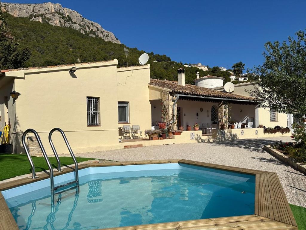 a swimming pool in front of a house at Chalet Cucarres in Calpe
