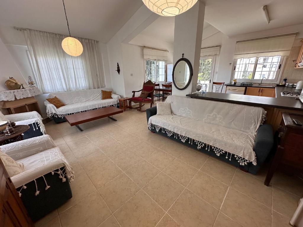 a large living room with couches and a mirror at Kyrenia center 3 bedroom apartment in Kérynia