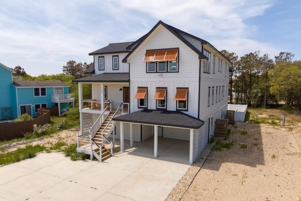 an aerial view of a house with a porch at Aurora 6 BR Elevator Theater Rec Room Pool & Hot in Corolla