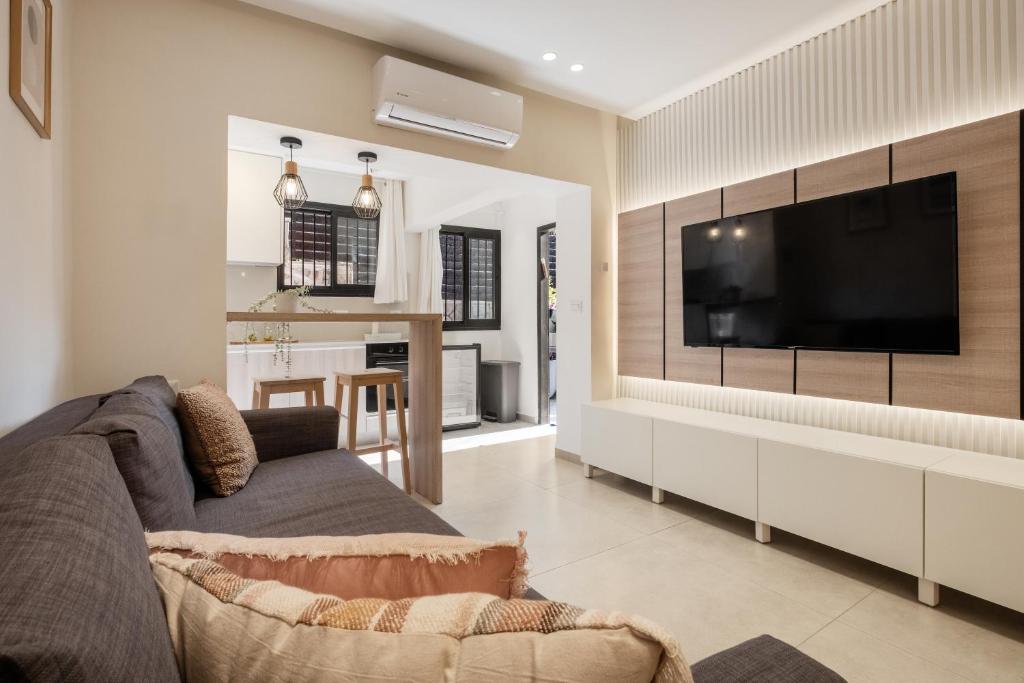 a living room with a large flat screen tv at family apartment in Jerusalem