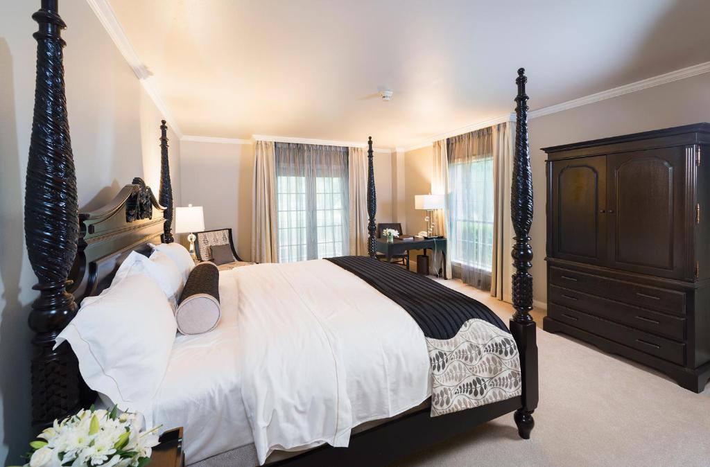 a bedroom with a large bed and a dresser at Cooper Hotel Conference Center & Spa in Dallas