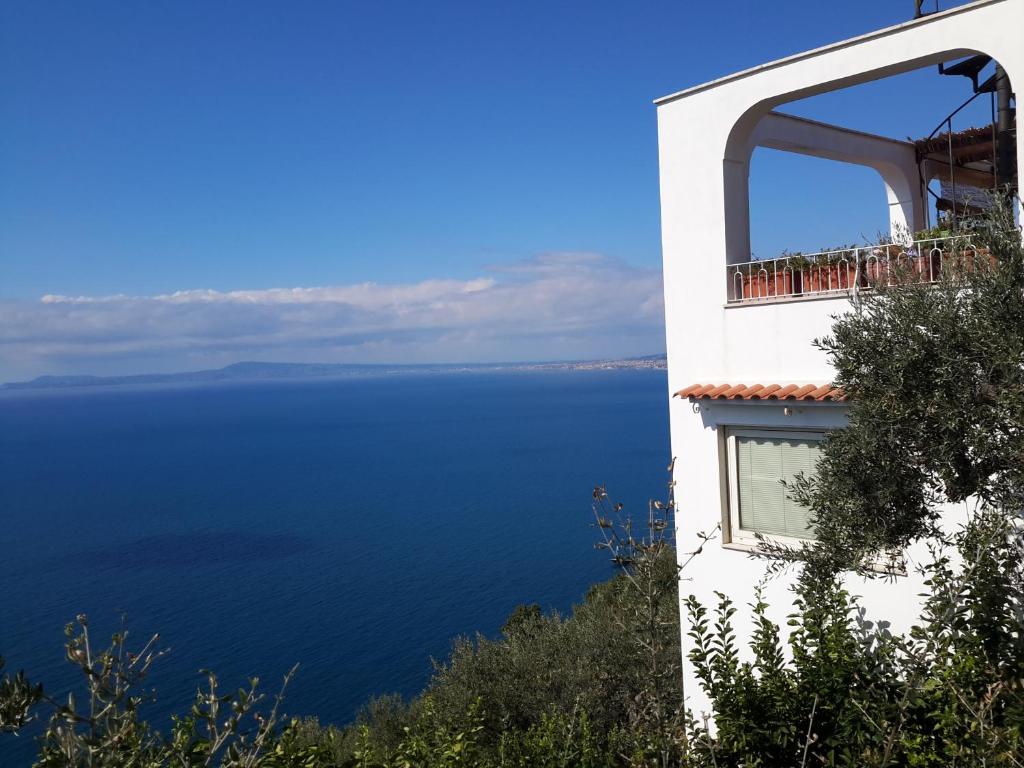 a building with a view of the water at Ambrosio home in Vico Equense