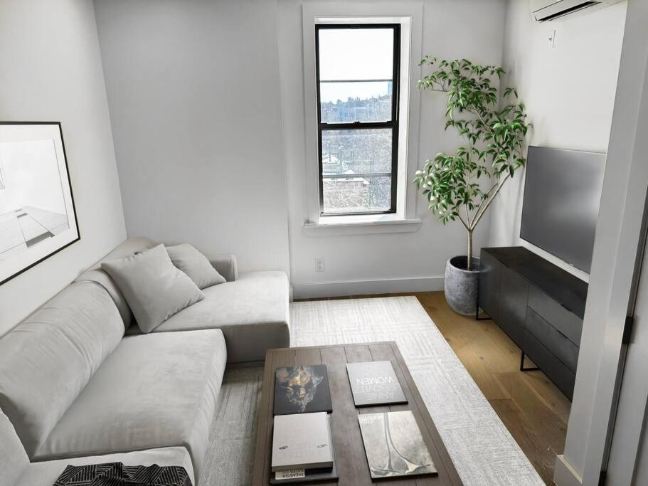 a living room with a couch and a table at Newly renovated massive three bedroom! in New York