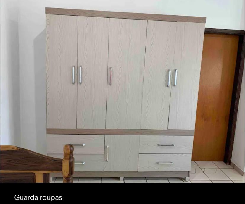 a large white cabinet in a room at Suíte com ar-condicionado (Família Hassan) in Corumbá