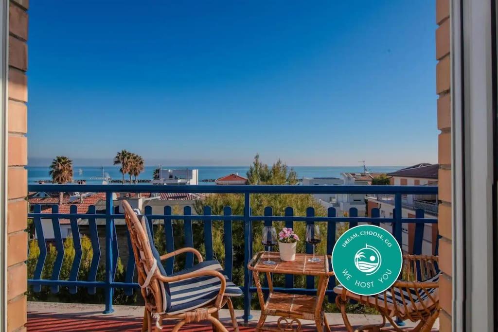 a balcony with two chairs and a table with a view of the ocean at [Sea View] Appartamento Panoramico Wifi A/C in Porto San Giorgio