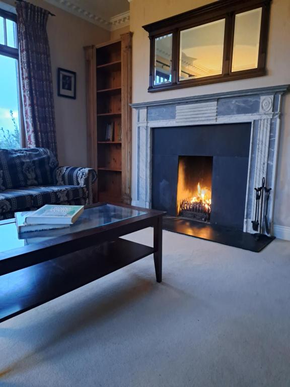 a living room with a fireplace and a coffee table at House in the countryside in Cork