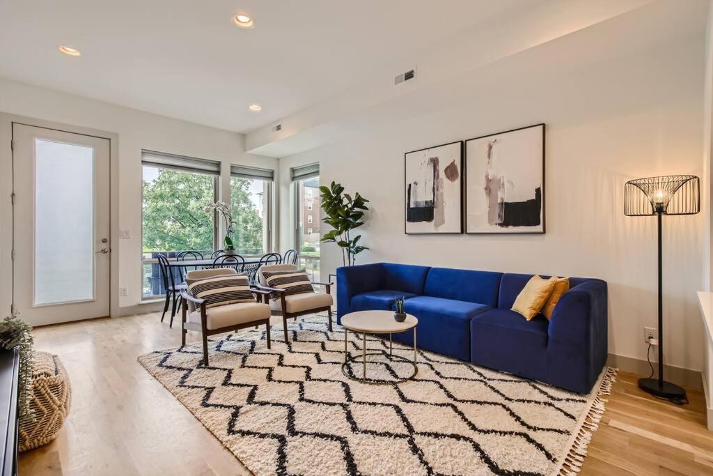 a living room with a blue couch and a table at Upscale Townhome w/ Stunning Rooftop Views in Denver