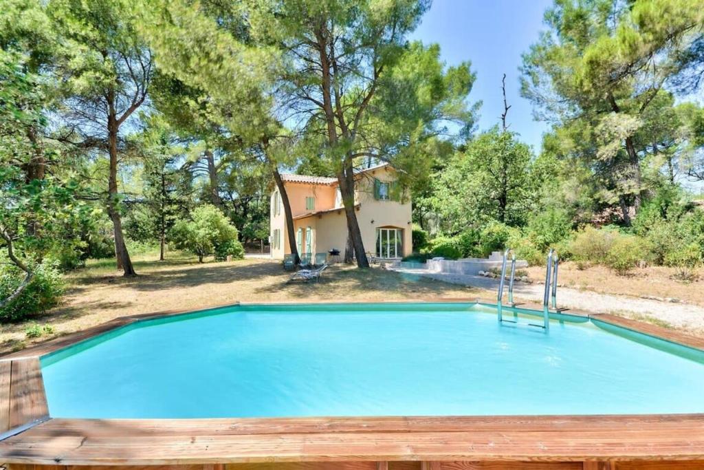 a large swimming pool in front of a house at Pinède house furnished in Aix-en-Provence