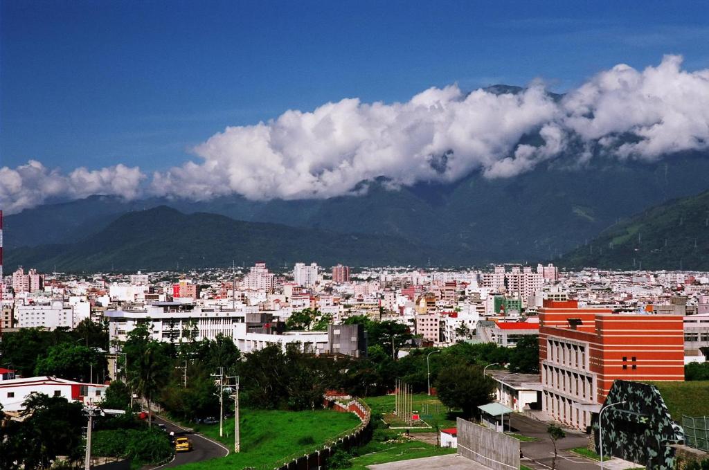 a view of a city with buildings and mountains at Zhileju Homestay in Hualien City