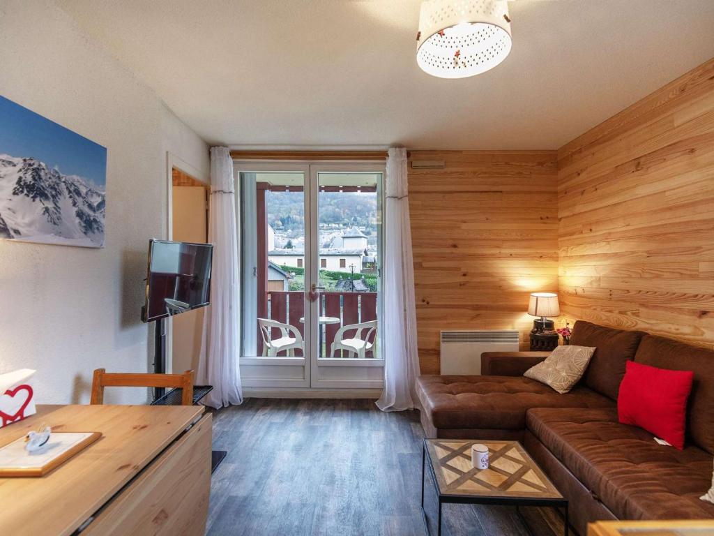 a living room with a couch and a large window at Charmant T2 cabine 3 pers, balcon, parking privé, Luz-Saint-Sauveur - FR-1-402-139 in Esquièze - Sère