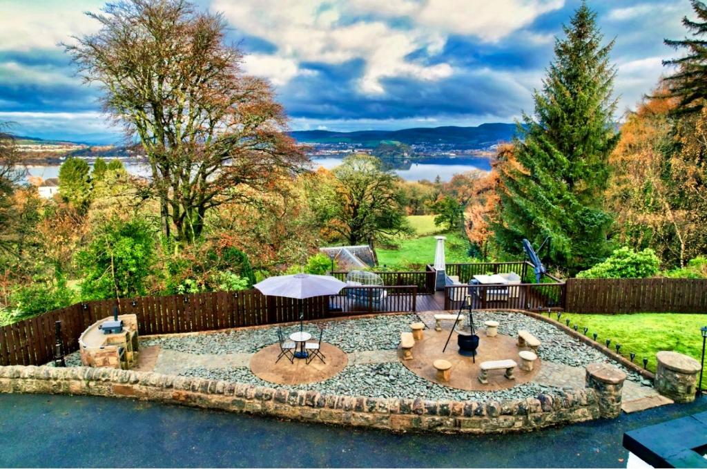 a backyard with a patio with a fire pit at Gleddoch Coach House in Langbank