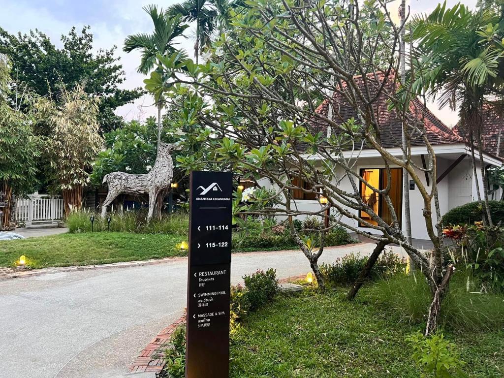 a sign in front of a house with a giraffe at ANANTAYA CHIANGMAI BOUTIQUE HOTEL in Chiang Mai