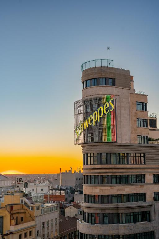 a building with a sign on the side of it at Hostal Charlotte-Gran Vía in Madrid