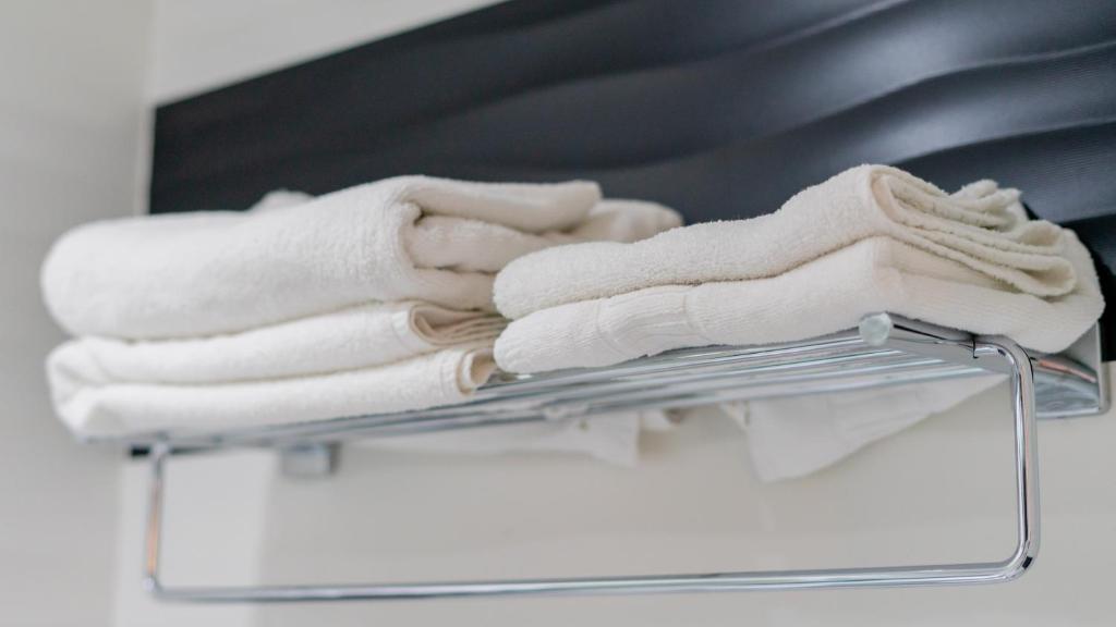 a pile of towels on a towel rack at Hostal Charlotte-Gran Vía in Madrid