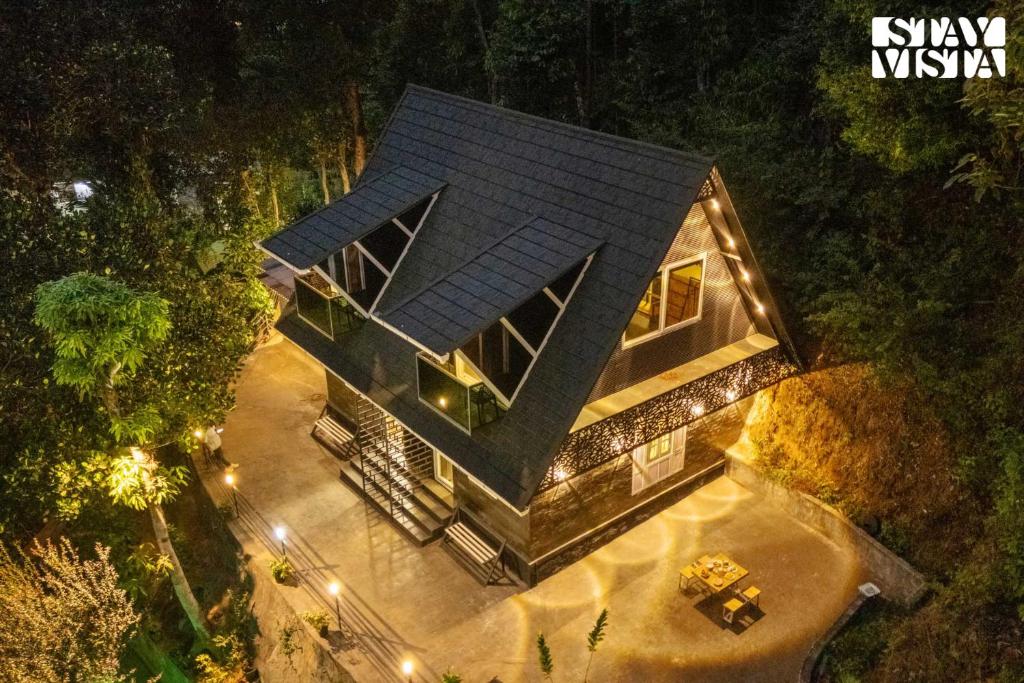 an overhead view of a house in the woods at night at StayVista at The Black Bean Cottage with Breakfast Included & Pet Friendly in Wayanad