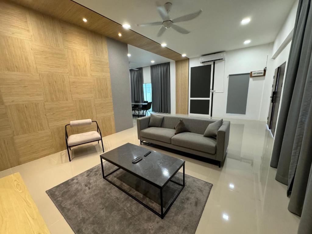 a living room with a couch and a coffee table at MR homestay depo link in Kuching