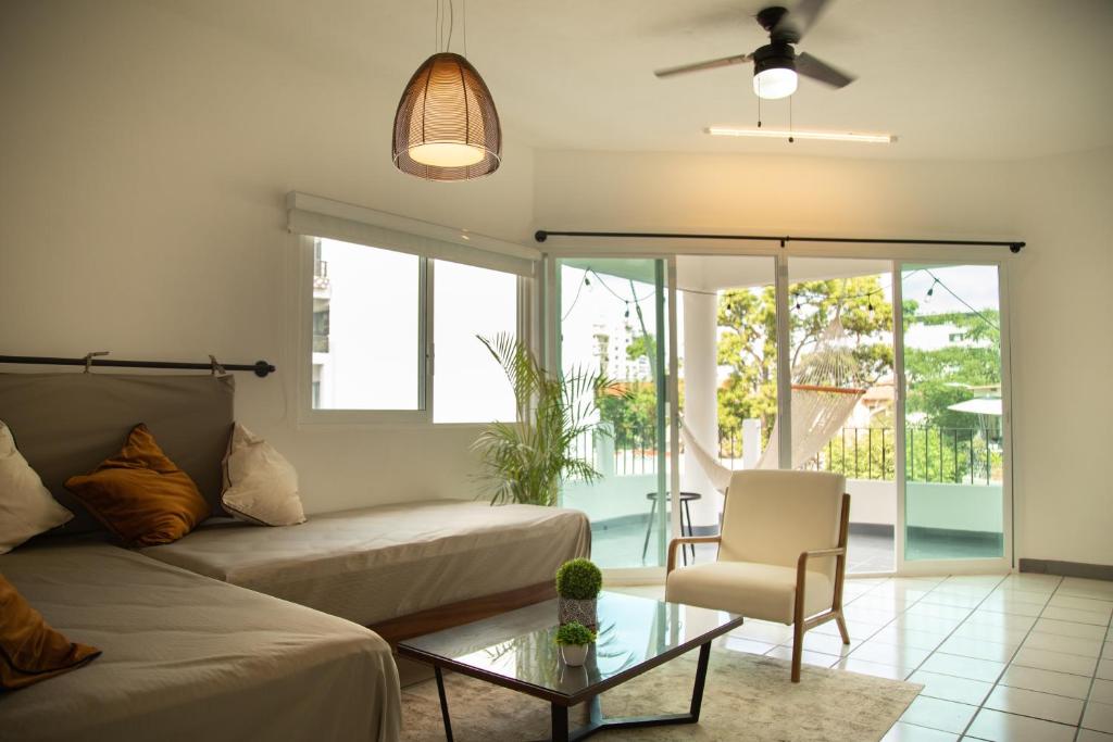 a living room with a couch and a table at Casa Carranza - Romantic Zone Suites in Puerto Vallarta