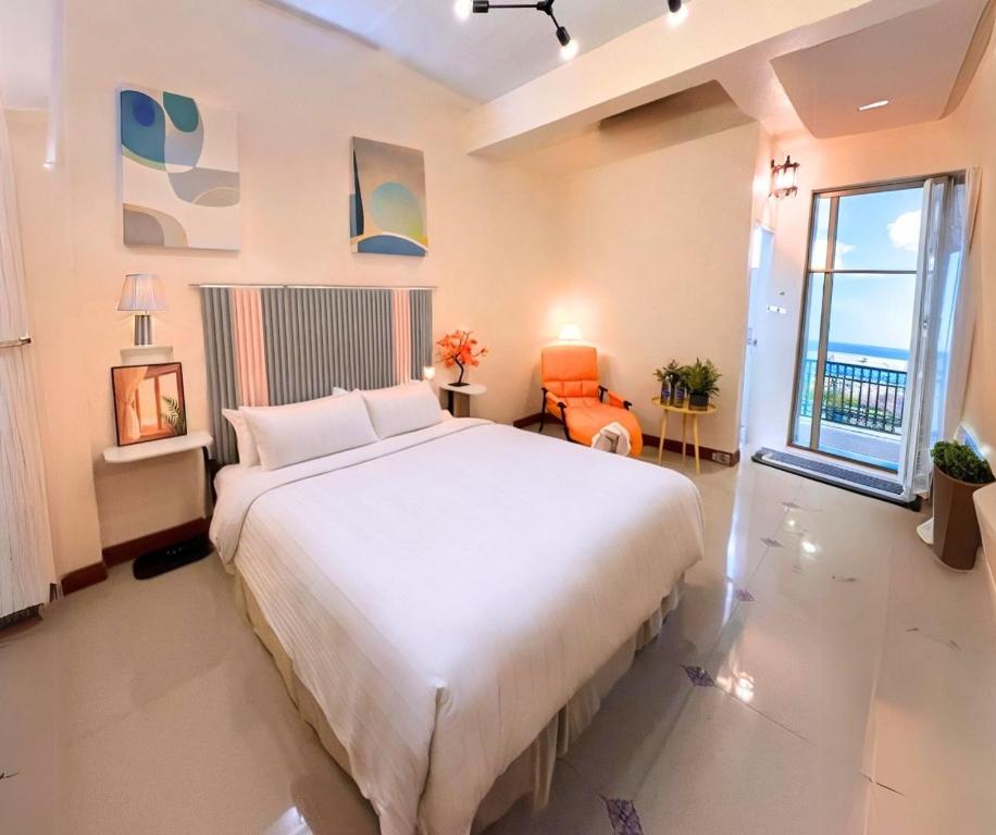 Un dormitorio con una gran cama blanca y una ventana en SCN City Hotel Rayong en Ban Chang