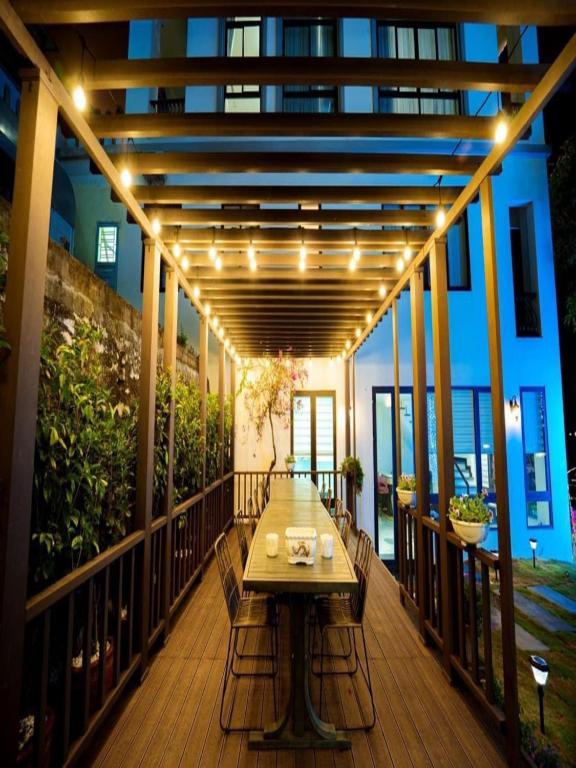 a wooden deck with a table on a balcony at Chuỗi Villa 7 Ngủ Beverly Hill - Bãi Cháy - Bể bơi vô cục in Ha Long